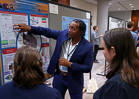 DOE LRGF fellow presenting a poster at the 2025 program review.